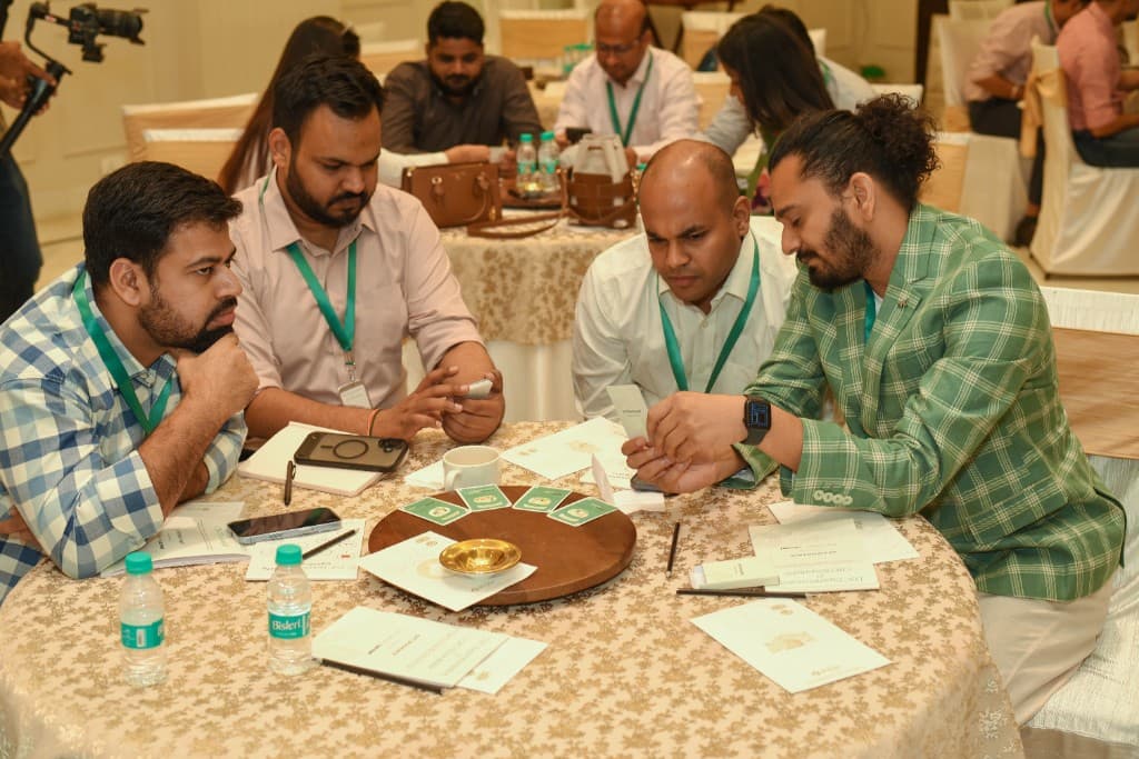 Team huddle around cognitive cards in an event breakout